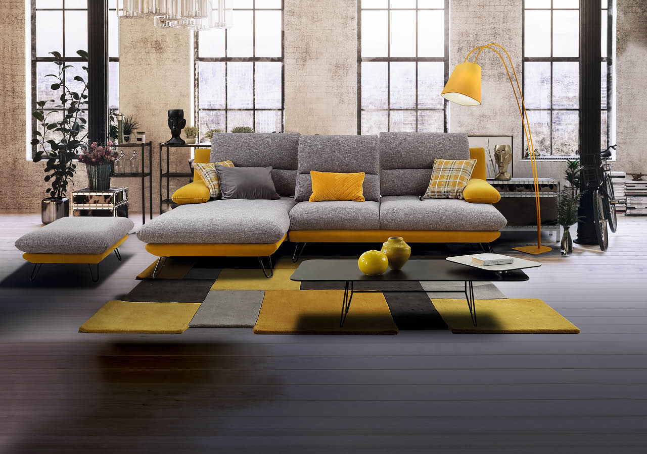 Converted loft interior with high graceful arched windows in a brick wall and modern lounge furniture with a potted tree and houseplants, 3d rendering